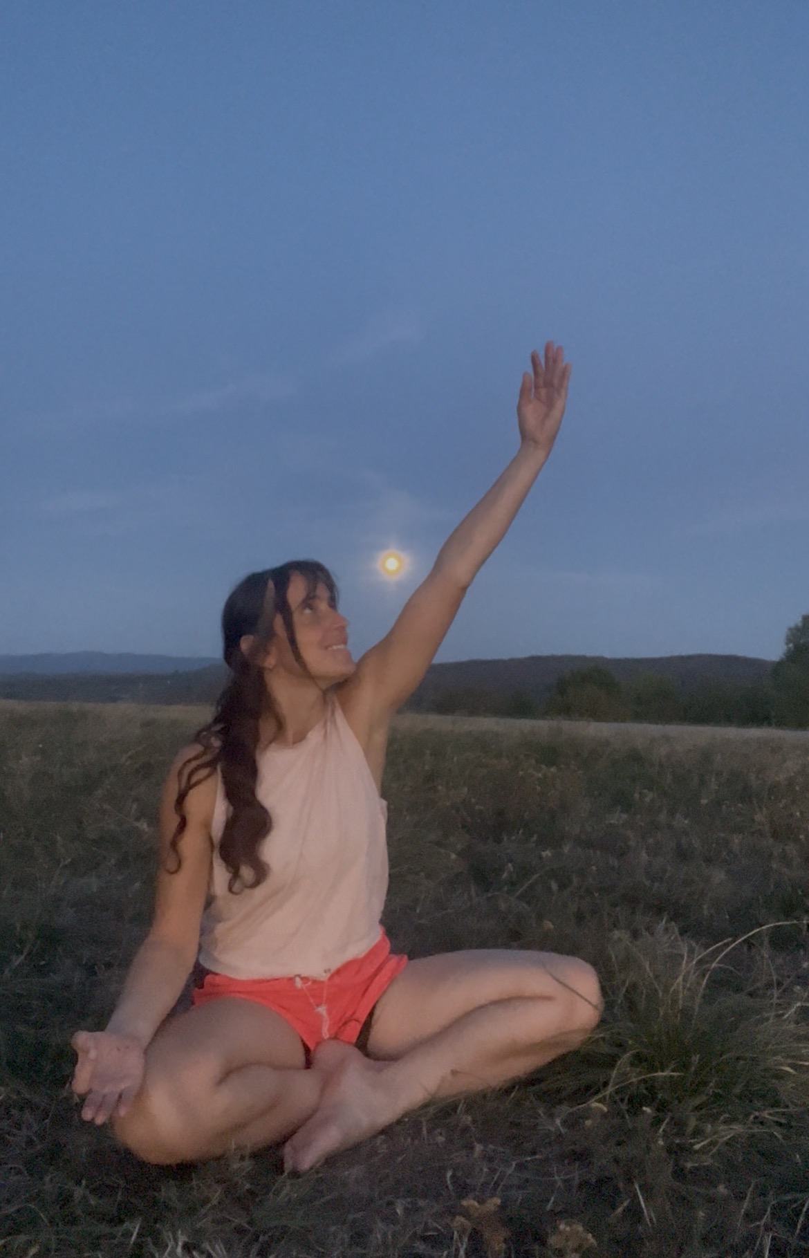 Gerta practicing yoga outdoors beneath the moon