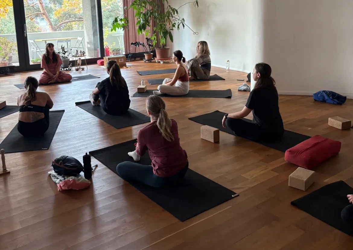 Community members sitting together after yoga practice